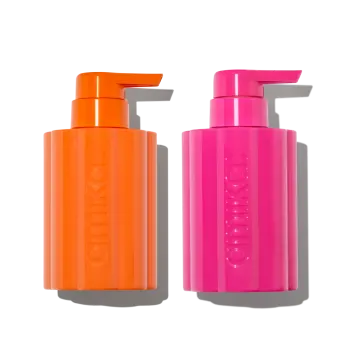a bottle of orange and pink liquid next to each other bottles