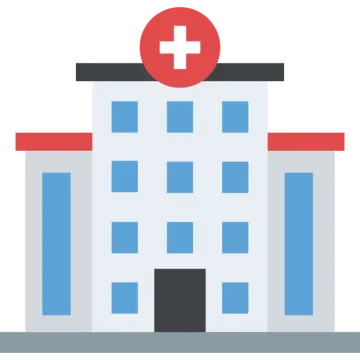 a hospital building with a red cross on top