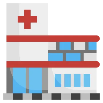a hospital building with a red cross on top