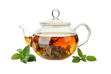a glass tea pot filled with green leaves