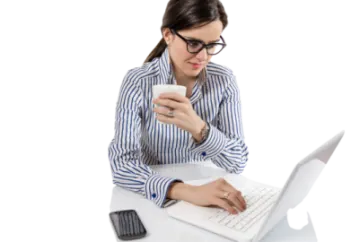 a woman sitting at a desk using her laptop