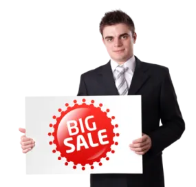 a man holding up a sign that says big sale