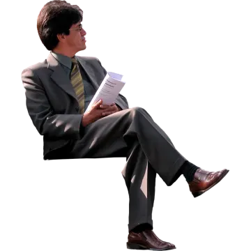 a man in a suit and tie sitting on a chair
