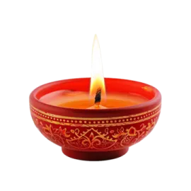 a red bowl with a lit candle in it
