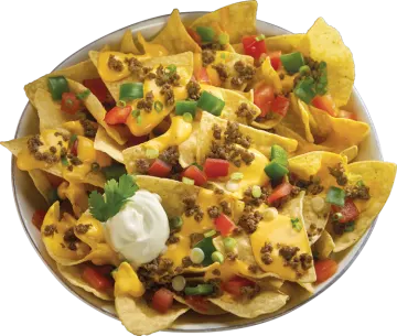 a bowl filled with nachos and topped with cheese
