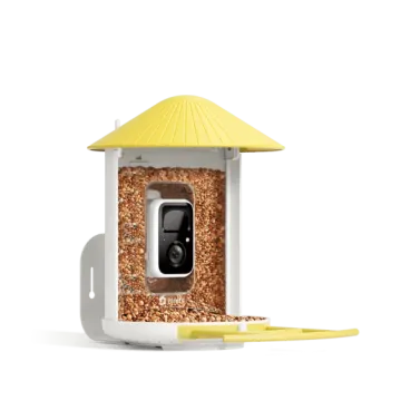a white bird feeder with a yellow roof
