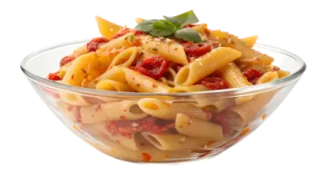 a glass bowl filled with pasta and sauce