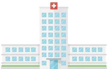 a hospital building with a red cross on top