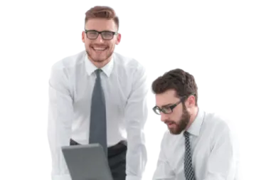 two men in white shirts and ties looking at a laptop