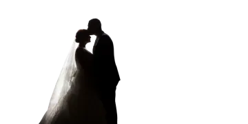 a bride and groom silhouetted against a white background