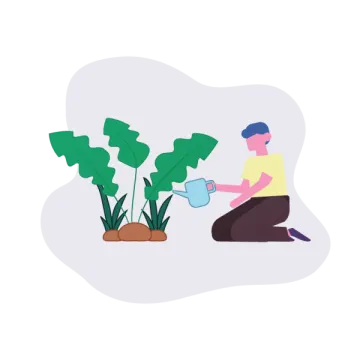 a person sitting on the ground with plants in their hands