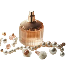 a bottle of perfume surrounded by pearls