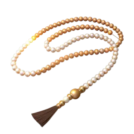 a white and brown rosary with a ta