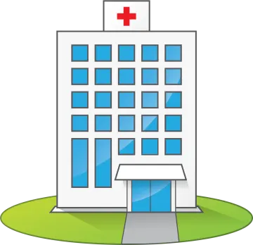 a hospital building with a red cross on top