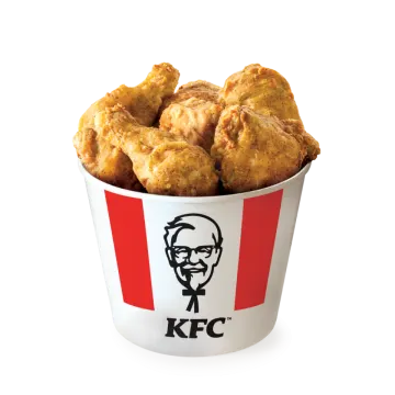 a cup filled with fried chicken sitting on top of a table