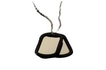 a black and white dog tag on a chain