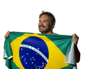 a man holding up a brazil flag