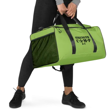 a man carrying a green gym bag