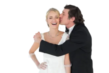 a bride and groom kissing on their wedding day
