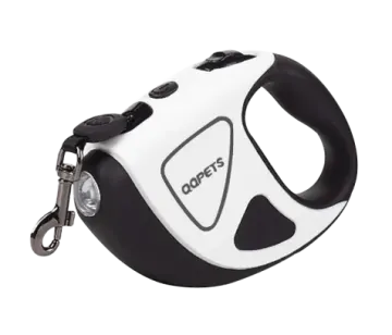 a white and black dog toy with a keychai