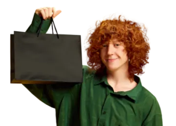 a woman holding up a black shopping bag
