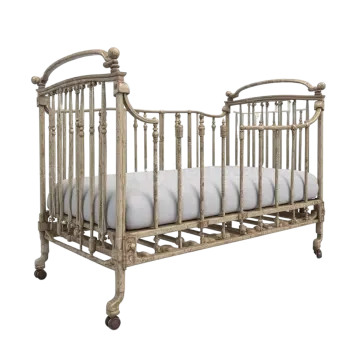 a wooden cribt with white sheets on it