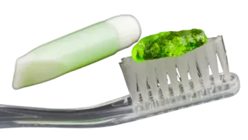 a close up of a tooth with a green toothbrush