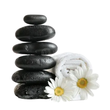 a stack of black stones with white flowers on top