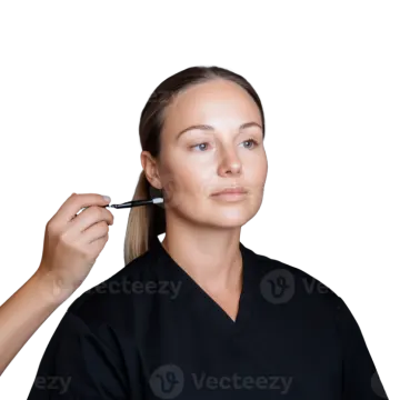 a woman getting her eyebrows done with a brush