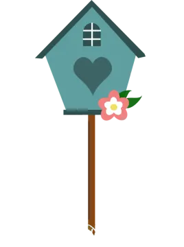 a bird house with a flower in the grass