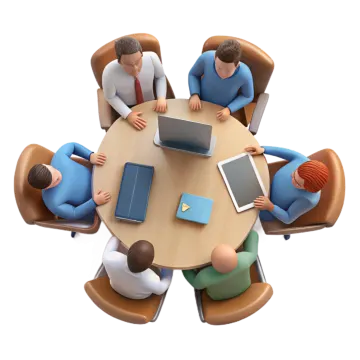 a group of people sitting around a table with laptops