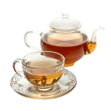 a glass teapot with a cup and saucer