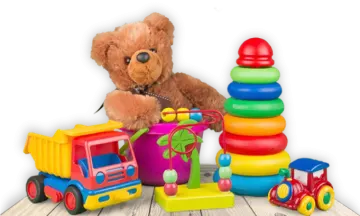 a teddy bear sitting next to a pile of toys