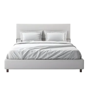 a bed with white sheets and pillows on it