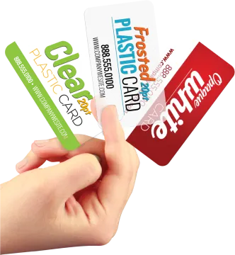a hand holding three different business cards