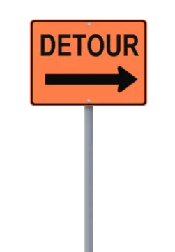 a street sign with the word detur on it
