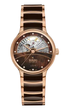 a rose gold watch with a brown dial