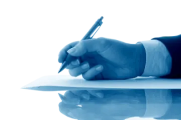a person writing on a piece of paper