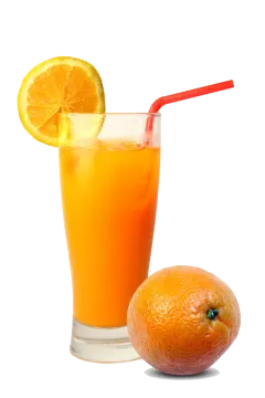 a glass of orange juice next to an orange