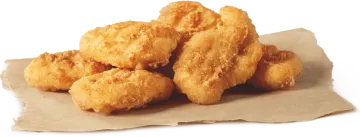 a pile of fried chicken nus on a piece of paper