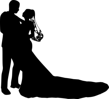 a silhouette of a bride and groom kissing
