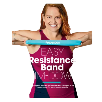 a woman in a pink tank top holding a blue yoga mat