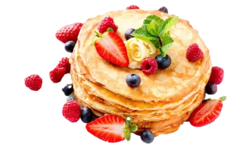 a stack of pancakes with berries and mint on top