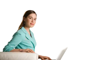 a woman sitting on a couch using a laptop