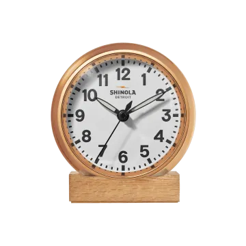 a wooden clock on a white background