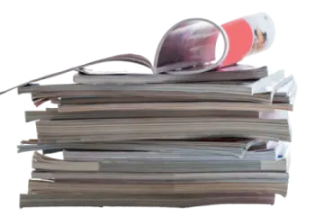 a stack of newspapers with a magni on top