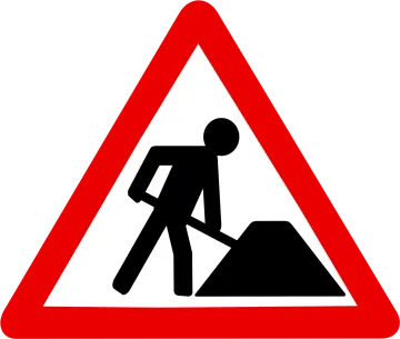 a road sign with a man digging dirt