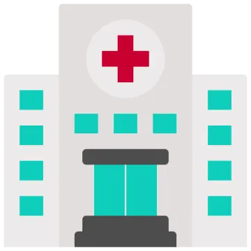 a hospital building with a red cross on top