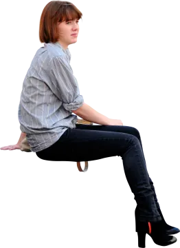a woman sitting on a chair with her legs crossed