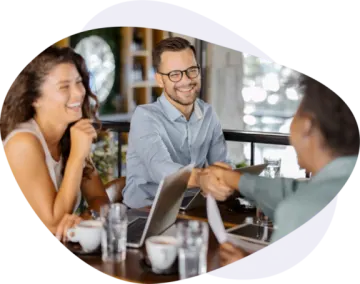 a man and woman sitting at a table talking to each other people